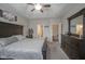 Comfortable bedroom with a tray ceiling, and a view of the en suite bathroom and closet at 1299 W Crystal Dr, Fortville, IN 46040