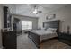 Spacious bedroom with a tray ceiling, complemented by dark furniture, and natural light at 1299 W Crystal Dr, Fortville, IN 46040