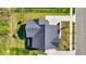 A top-down view of a home's roof and backyard, including a playset and lush lawn at 14349 Marsdale Pl, Carmel, IN 46074