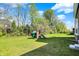 Spacious backyard featuring a wooden playset with a slide, swing, and climbing structure at 14349 Marsdale Pl, Carmel, IN 46074