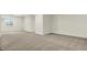 Expansive unfinished basement with natural light, neutral carpet, offering versatility for various uses at 14349 Marsdale Pl, Carmel, IN 46074