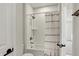 Well-lit bathroom with subway tile, shower-tub combo, brushed bronze fixtures, and decorative shower curtain at 14349 Marsdale Pl, Carmel, IN 46074
