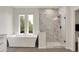 Bright bathroom featuring a soaking tub, glass shower, and vanity with a neutral color palette at 14349 Marsdale Pl, Carmel, IN 46074