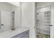 Bright bathroom with gray vanity, chrome fixtures, a mirror, and an open doorway to a shower-tub combo at 14349 Marsdale Pl, Carmel, IN 46074