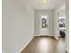 Bright entryway with hardwood floors, a transom window above the door, and a view into the house at 14349 Marsdale Pl, Carmel, IN 46074