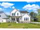 Charming two-story home featuring a well-manicured lawn, stone accents, and a welcoming front porch at 14349 Marsdale Pl, Carmel, IN 46074