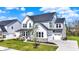 Beautiful home showcasing a lush lawn, stone accents, and a convenient attached two-car garage at 14349 Marsdale Pl, Carmel, IN 46074