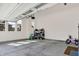 Bright garage with a high ceiling, featuring open storage and a view to the yard at 14349 Marsdale Pl, Carmel, IN 46074