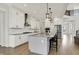 Open kitchen with granite island, pendant lighting, stainless steel appliances, and ample cabinet space at 14349 Marsdale Pl, Carmel, IN 46074