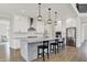 Modern kitchen features a large center island with seating, stainless steel appliances, and white cabinetry at 14349 Marsdale Pl, Carmel, IN 46074