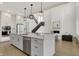 Spacious kitchen features an island with a sink, stainless steel appliances, and lots of storage at 14349 Marsdale Pl, Carmel, IN 46074