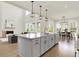 Gourmet kitchen with island, granite countertops, stainless steel appliances, and open to living area at 14349 Marsdale Pl, Carmel, IN 46074