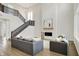 Bright living room with soaring ceilings, fireplace, and staircase with black railings at 14349 Marsdale Pl, Carmel, IN 46074