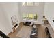Open-concept living room with fireplace, large windows, and modern gray sofa at 14349 Marsdale Pl, Carmel, IN 46074