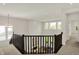 Upstairs loft with a dark wood banister, plenty of natural light, and an open floor plan at 14349 Marsdale Pl, Carmel, IN 46074