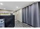 Basement space with grey curtains, access to an outside door and vinyl plank flooring at 1476 N Illinois St, Indianapolis, IN 46202