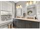 Bright bathroom featuring a double vanity with a marble countertop and stylish lighting fixtures at 1476 N Illinois St, Indianapolis, IN 46202