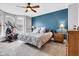 Comfortable bedroom features include a ceiling fan, gray walls, and a bay window at 1476 N Illinois St, Indianapolis, IN 46202