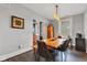 Comfortable dining room with a wood table, bench, and four chairs lit by a modern light fixture at 1476 N Illinois St, Indianapolis, IN 46202