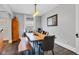 Charming dining room with modern light fixture, wood table and bench, and stylish seating at 1476 N Illinois St, Indianapolis, IN 46202