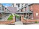 Exterior perspective showcases a row of red brick townhomes with landscaped courtyard and gated entry at 1476 N Illinois St, Indianapolis, IN 46202