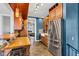 Well-lit kitchen with modern appliances, farm sink, tiled backsplash, and adjacent cozy living area at 1476 N Illinois St, Indianapolis, IN 46202