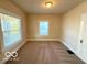 Bedroom featuring two windows for ample natural light, neutral walls, and carpeted flooring at 1510 W 22Nd St, Indianapolis, IN 46202