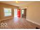 Bright living room featuring updated flooring, a red front door, and neutral walls at 1510 W 22Nd St, Indianapolis, IN 46202