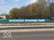 Riverside Regional Park sign on a sunny day with a tree-lined background at 1510 W 22Nd St, Indianapolis, IN 46202