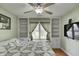 Comfortable bedroom featuring a ceiling fan, a mounted TV, built-in shelves, and a window seat at 1910 Riverstone Ct, Westfield, IN 46074