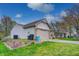 View of the home's side exterior, attached garage and landscaped yard at 1910 Riverstone Ct, Westfield, IN 46074