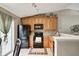 Charming kitchen featuring wood cabinets, black appliances, track lighting, and tile backsplash at 1910 Riverstone Ct, Westfield, IN 46074