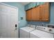 Functional laundry room with washer, dryer, and overhead cabinets in a well-lit space at 1910 Riverstone Ct, Westfield, IN 46074