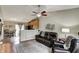 Cozy living room featuring wood floors, a ceiling fan, and an open floor plan to the kitchen at 1910 Riverstone Ct, Westfield, IN 46074