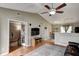 Bright living room featuring wood floors, a ceiling fan, and a view to an adjacent office at 1910 Riverstone Ct, Westfield, IN 46074