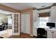 View to a built-in desk in an office with light wood floors and a white built-in cabinet at 1910 Riverstone Ct, Westfield, IN 46074