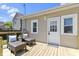 A cozy back deck features woven chairs, a table, and access to the home at 2005 Carrollton Ave, Indianapolis, IN 46202