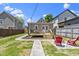 Backyard showcasing a deck area, fire pit and a spacious lawn at 2005 Carrollton Ave, Indianapolis, IN 46202