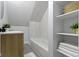 Bright bathroom featuring a tub/shower combo and built-in shelving at 2005 Carrollton Ave, Indianapolis, IN 46202