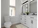 Bright bathroom featuring a white vanity with black hardware and a plush rug at 2005 Carrollton Ave, Indianapolis, IN 46202