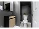 Modern half-bathroom with sleek black mirror, modern vanity and white toilet at 2005 Carrollton Ave, Indianapolis, IN 46202