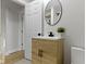 Bathroom vanity featuring a wood cabinet, round mirror, and modern fixtures at 2005 Carrollton Ave, Indianapolis, IN 46202