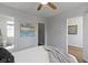 Comfortable bedroom features a ceiling fan, neutral gray accents, and bright natural light at 2005 Carrollton Ave, Indianapolis, IN 46202