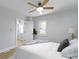Comfortable bedroom features a ceiling fan, neutral gray accents, and bright natural light at 2005 Carrollton Ave, Indianapolis, IN 46202