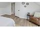 Bedroom featuring wood floors, an accent chair, and round wall mirrors at 2005 Carrollton Ave, Indianapolis, IN 46202