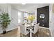 Bright dining room with table set for four, dark accent wall, and access to the modern kitchen at 2005 Carrollton Ave, Indianapolis, IN 46202