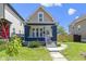 Charming home with a welcoming front porch, landscaped yard, and a classic two-story design at 2005 Carrollton Ave, Indianapolis, IN 46202