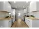Modern kitchen boasts white cabinets, wood countertops, stainless steel appliances and luxury vinyl plank flooring at 2005 Carrollton Ave, Indianapolis, IN 46202
