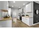 Modern kitchen features white cabinets, wood countertops, stainless steel appliances, dark accent wall and lighting at 2005 Carrollton Ave, Indianapolis, IN 46202