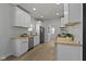 Modern kitchen boasts white cabinets, wood countertops, stainless steel appliances and luxury vinyl plank flooring at 2005 Carrollton Ave, Indianapolis, IN 46202